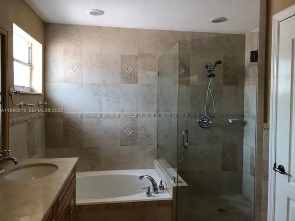 a bathroom with a sink and shower