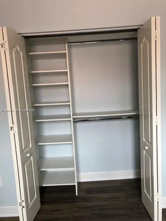 a view of walk in closet with empty racks
