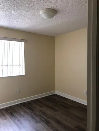 a view of room with window and hardwood floor