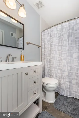 a bathroom with a sink toilet and mirror