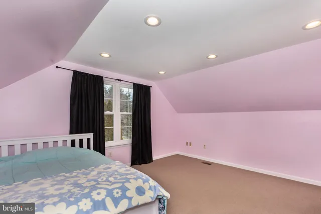 a large room with a bed and a dresser