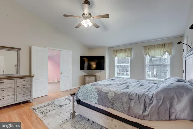 a bedroom with a large bed and a flat screen tv