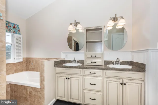 a bathroom with a sink vanity and mirror