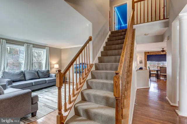 a view of entryway and hall with wooden floor