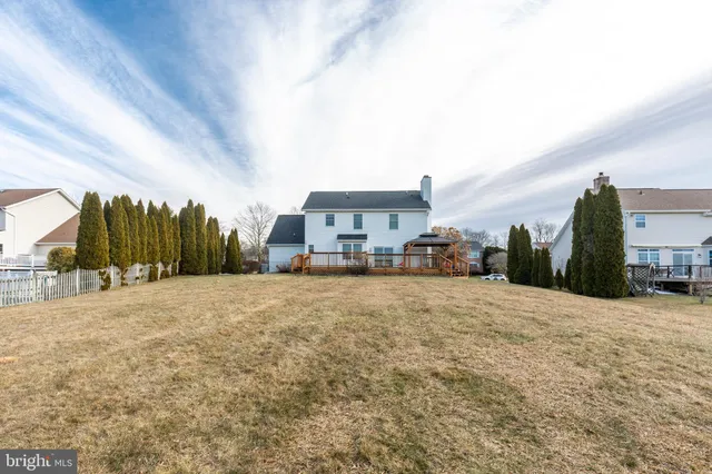 a view of a house with a yard and roof