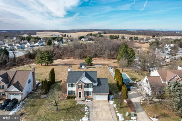 an aerial view of a house with swimming pool