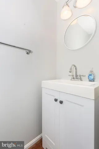 a bathroom with a sink and mirror