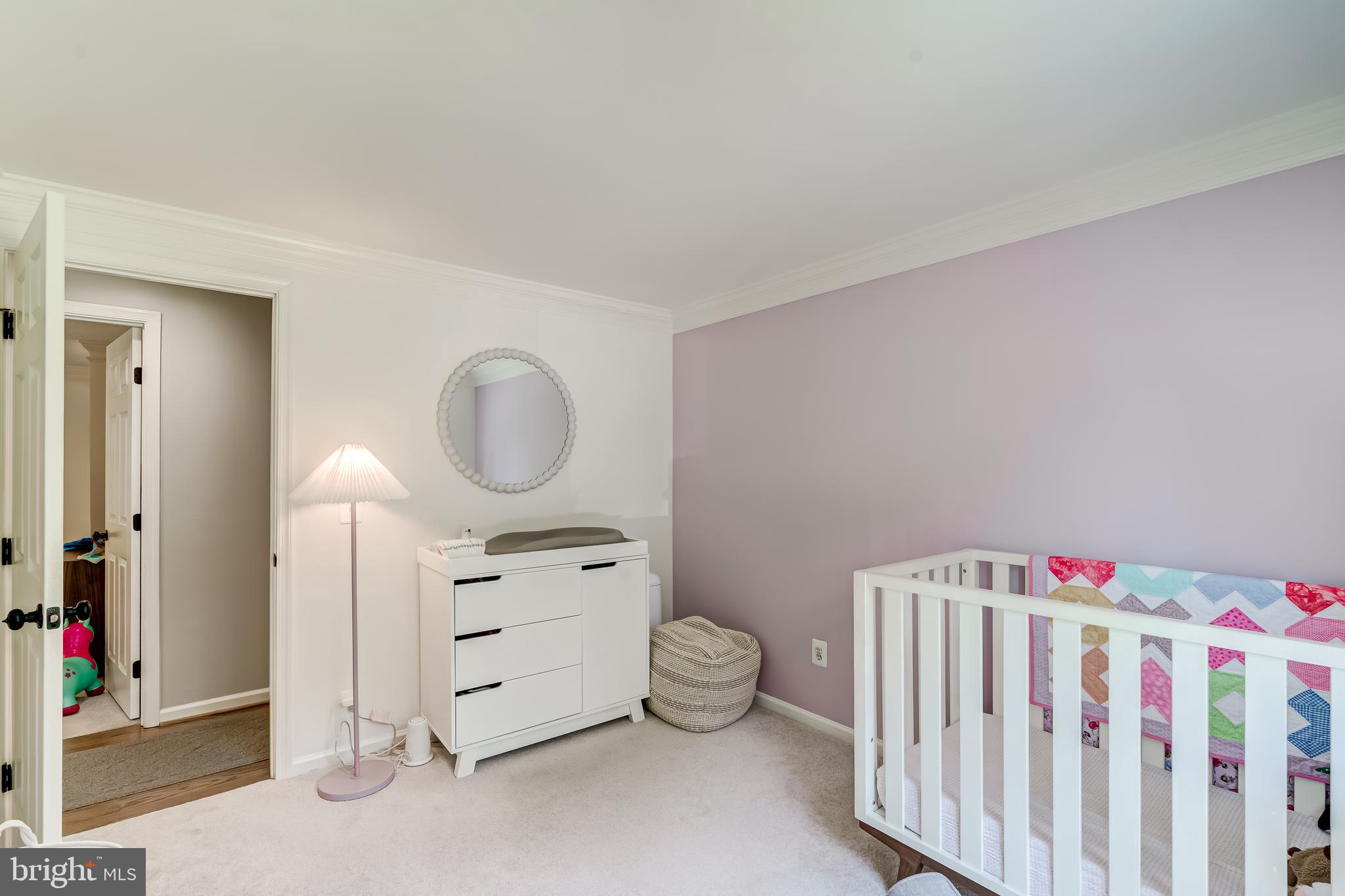 11926 Appling Valley Road Fairfax, VA 22030 - Photo 51 of 60 a bedroom with a baby bed a dresser and a window