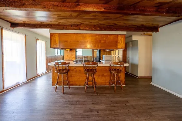 a dining room with furniture and wooden floor