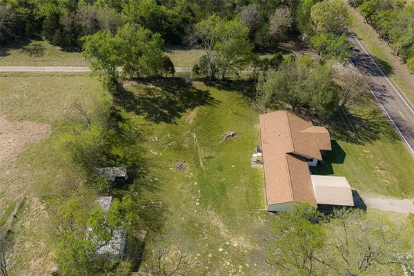 an aerial view of residential house with pool and yard