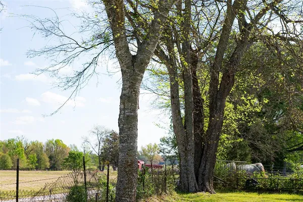 a front view of a house with a yard garden and patio