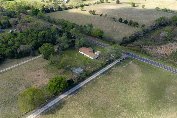 an aerial view of a house with a yard