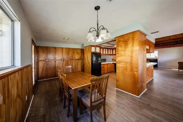 a view of a dining room with furniture wooden floor and a chandelier