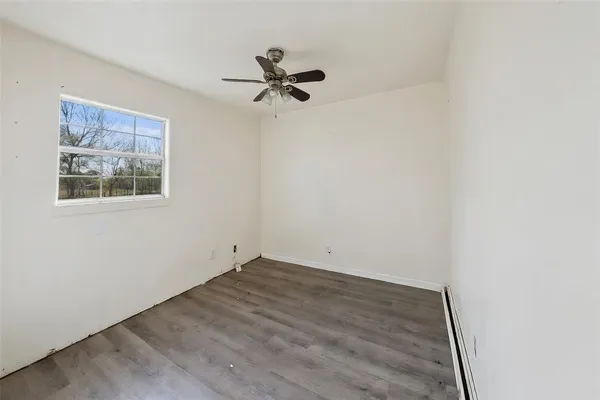 a view of a room with wooden floor and closet