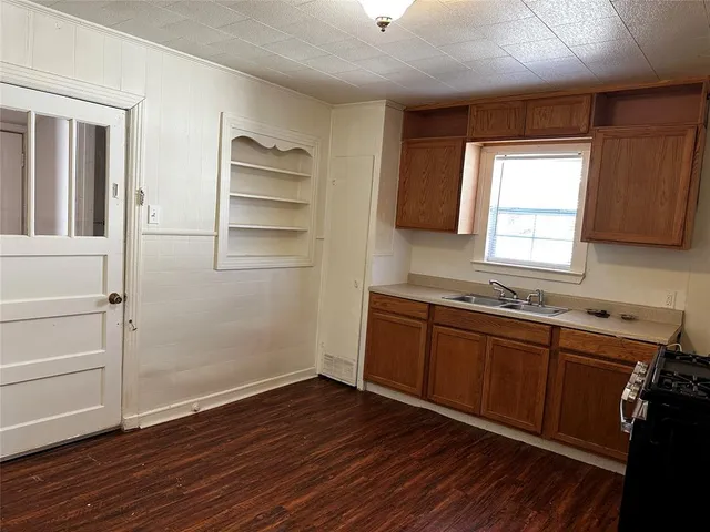 a room with wooden floors and window