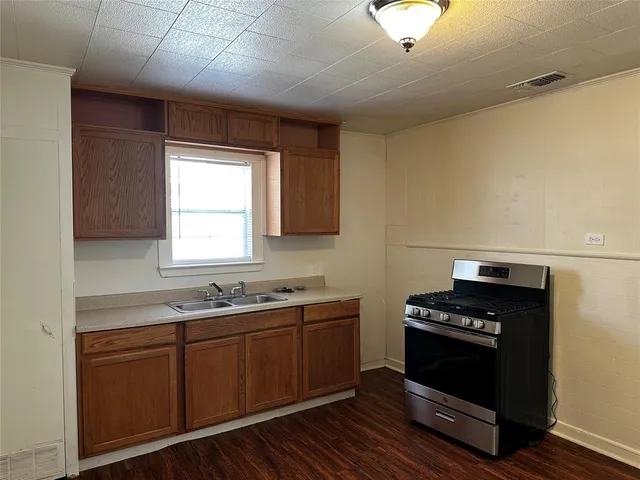 a kitchen with sink cabinets and appliances