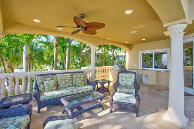 a view of a house with a swimming pool and sitting area