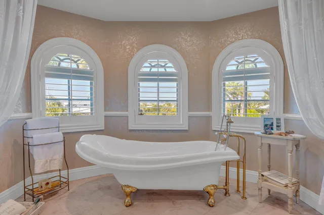 an aerial view of residential houses with outdoor space and trees