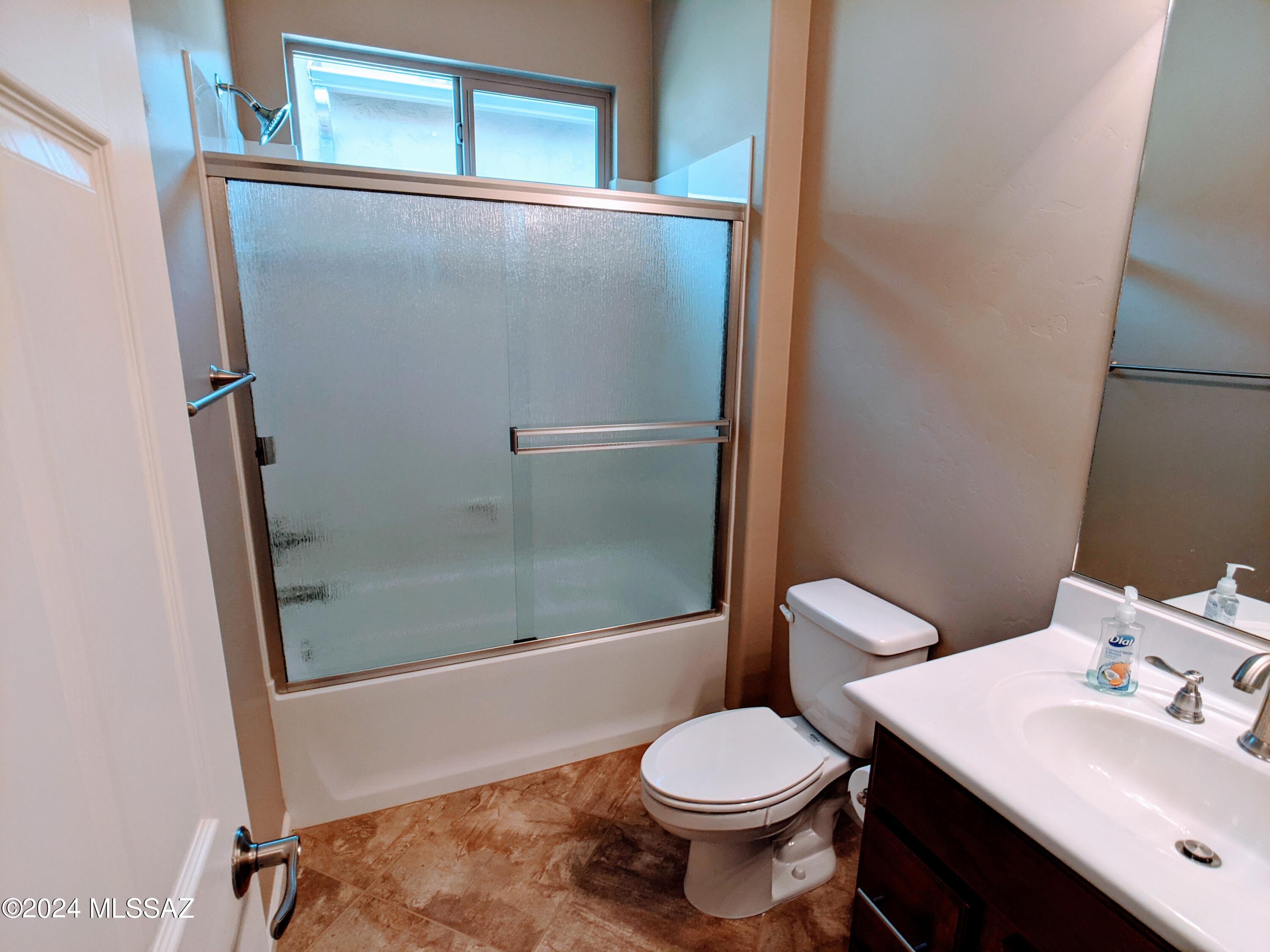 61021 East Slate Road Oracle, AZ 85623 - Photo 17 of 18 a bathroom with a sink mirror toilet and shower