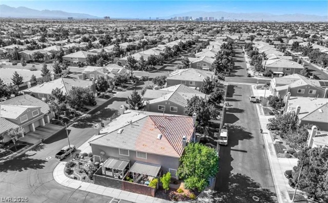 10247 Rising Tree Street Las Vegas, NV 89183 - Photo 3 of 7 An aerial perspective showcases a vibrant neighborhood, offering distant city views and expansive suburban living.
