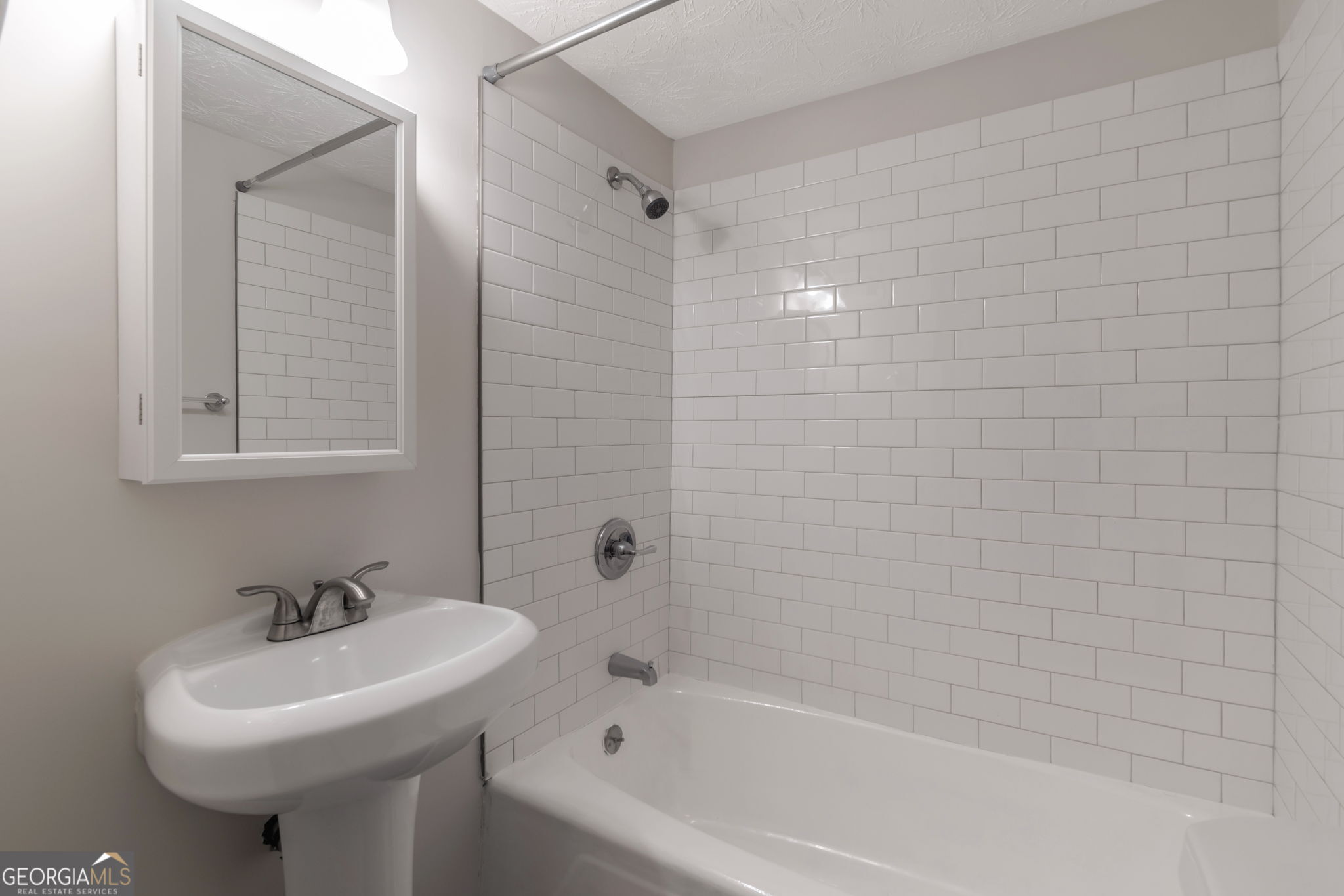 2364 Peachwood Circle Northeast, Unit 2366B Atlanta, GA 30345 - Photo 12 of 15 a bathroom with a sink a mirror and a bathtub