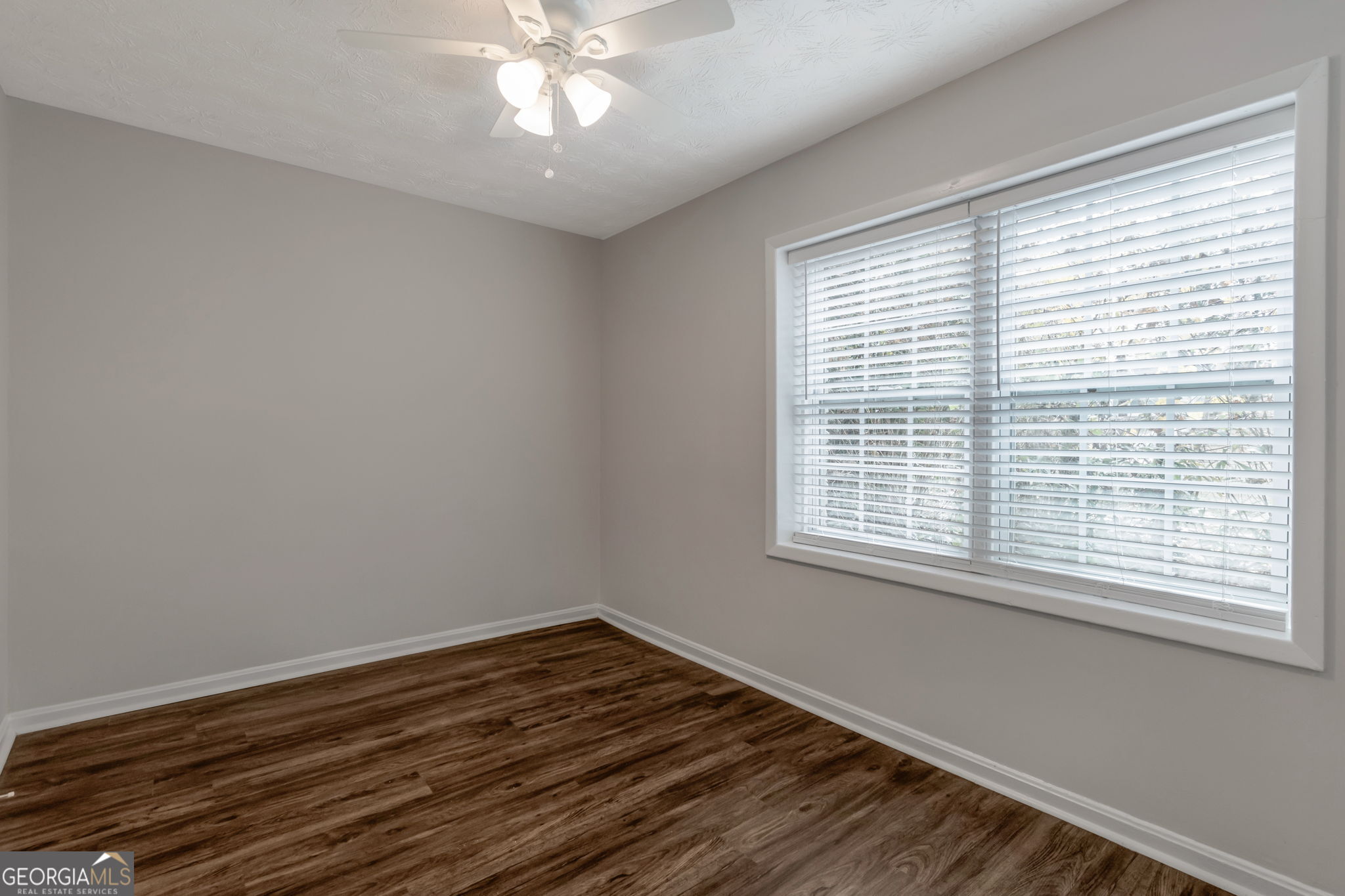 2364 Peachwood Circle Northeast, Unit 2366B Atlanta, GA 30345 - Photo 13 of 15 a view of an empty room with wooden floor and a window