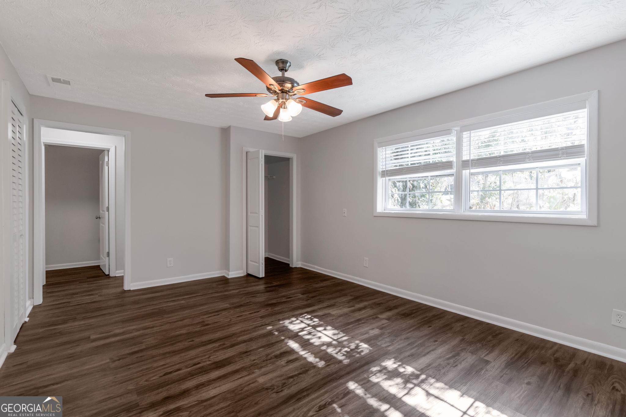 2364 Peachwood Circle Northeast, Unit 2366B Atlanta, GA 30345 - Photo 3 of 15 a view of empty room with wooden floor and fan