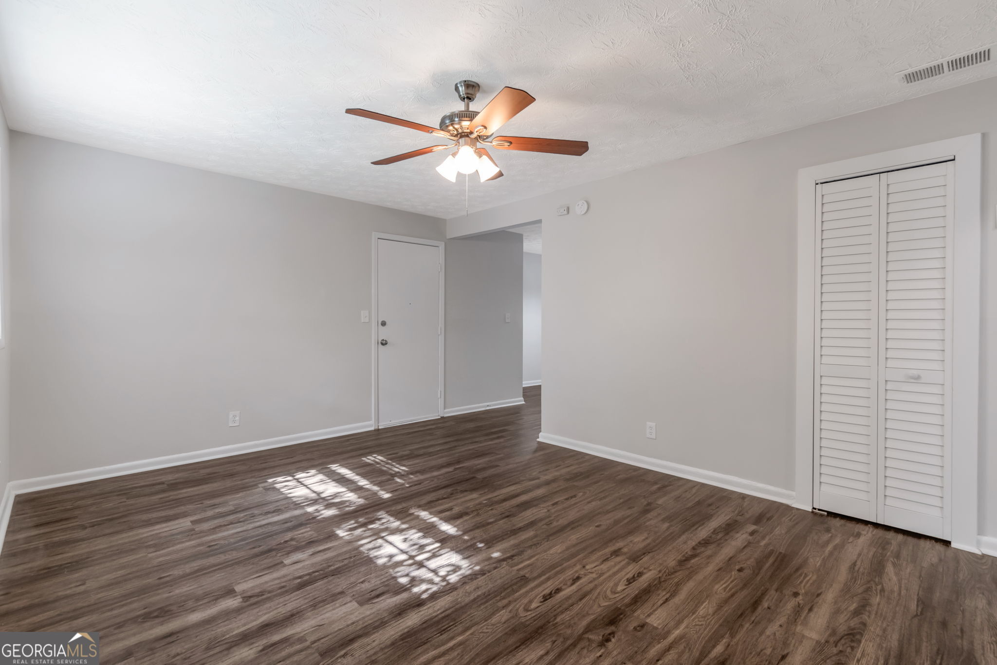 2364 Peachwood Circle Northeast, Unit 2366B Atlanta, GA 30345 - Photo 4 of 15 a view of an empty room with wooden floor and a window