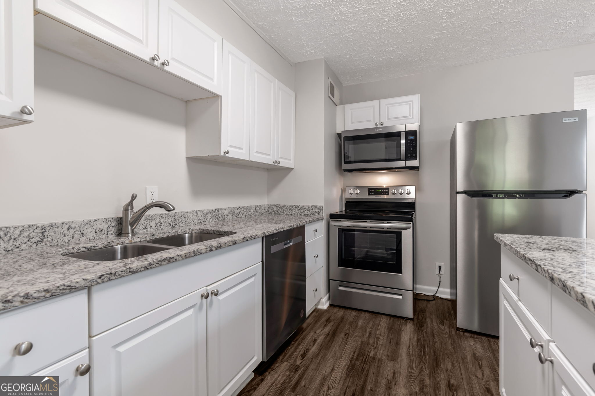 2364 Peachwood Circle Northeast, Unit 2366B Atlanta, GA 30345 - Photo 8 of 15 a kitchen with a sink and a stove top oven