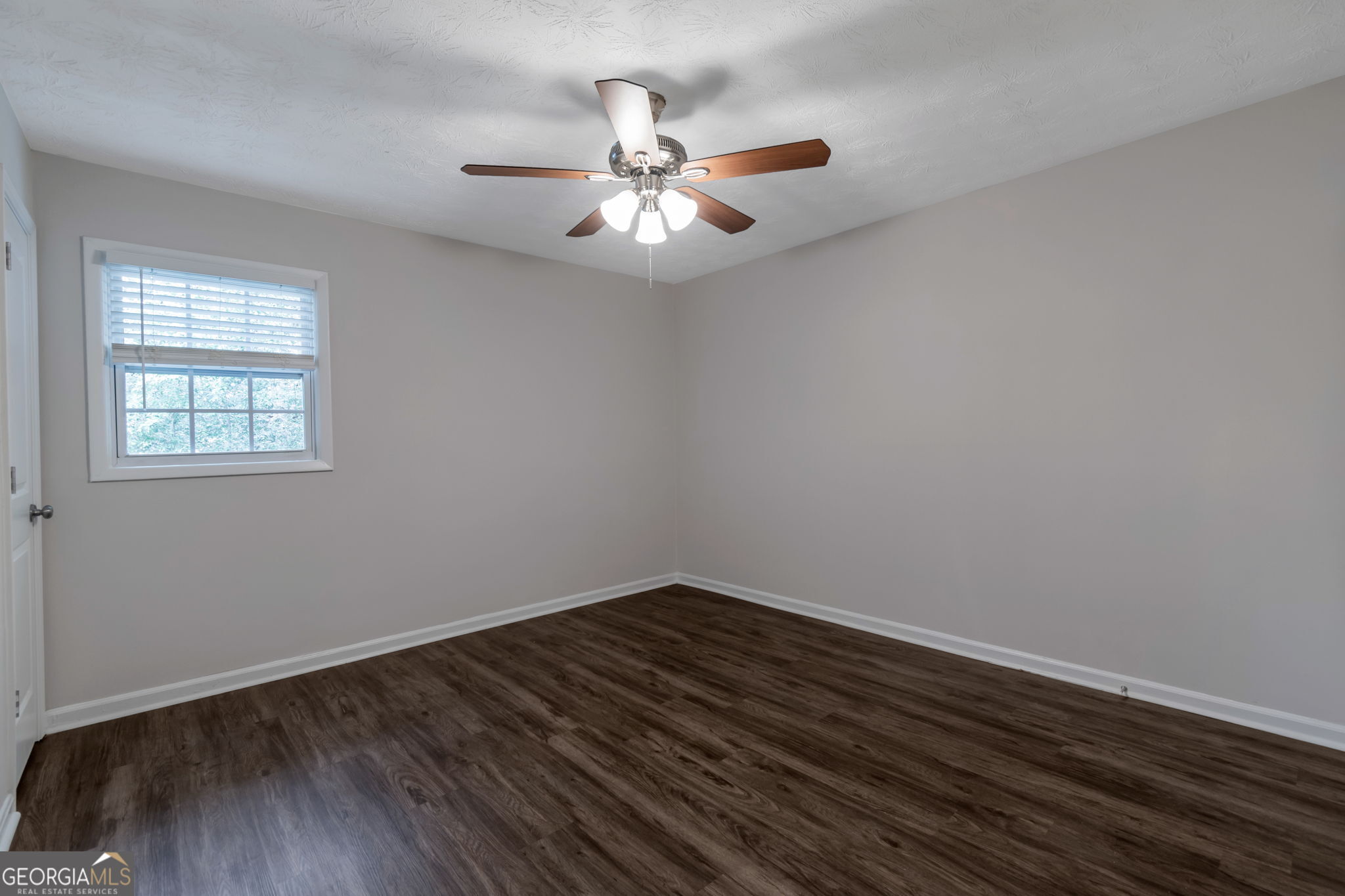 2364 Peachwood Circle Northeast, Unit 2366B Atlanta, GA 30345 - Photo 10 of 15 wooden floor in an empty room with a window