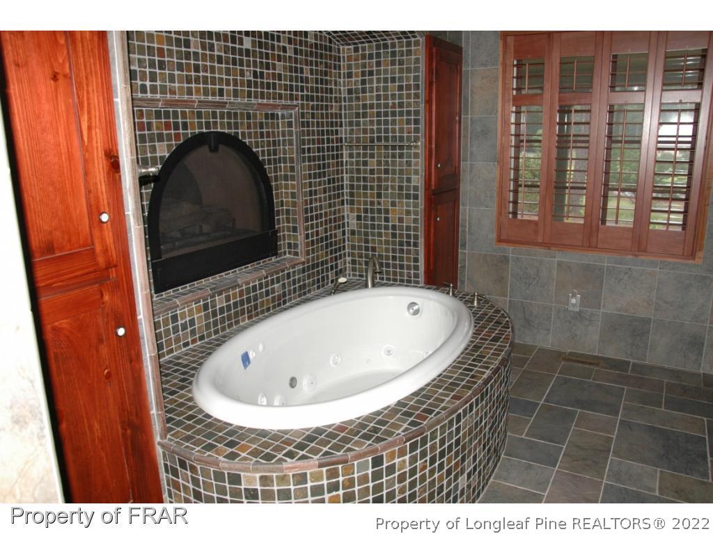 4949 Niagara Carthage Road Southern Pines, NC 28387 - Photo 12 of 18 a bathroom with a sink and a shower