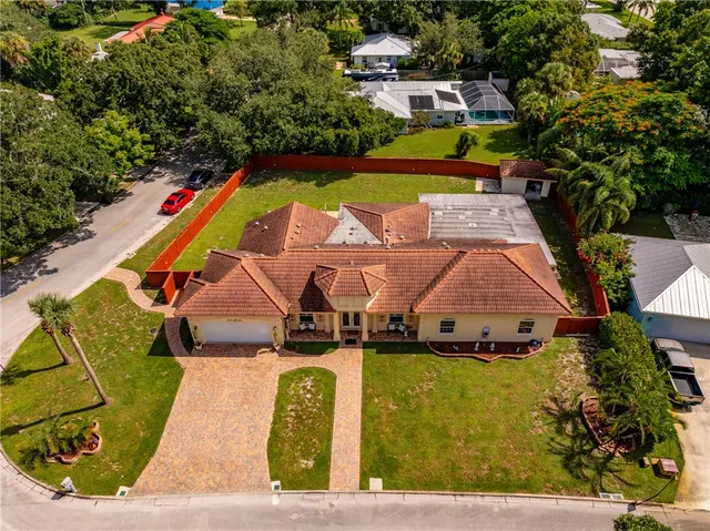 an aerial view of a house with a swimming pool