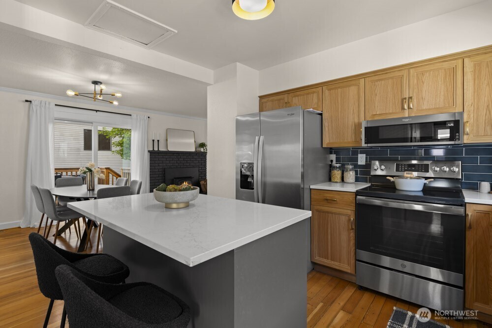 4146 47th Avenue Southwest Seattle, WA 98116 - Photo 11 of 40 a kitchen with a stove a refrigerator and a microwave