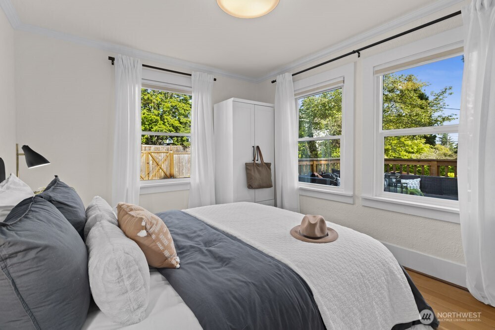 4146 47th Avenue Southwest Seattle, WA 98116 - Photo 13 of 40 a bedroom with a bed and a window