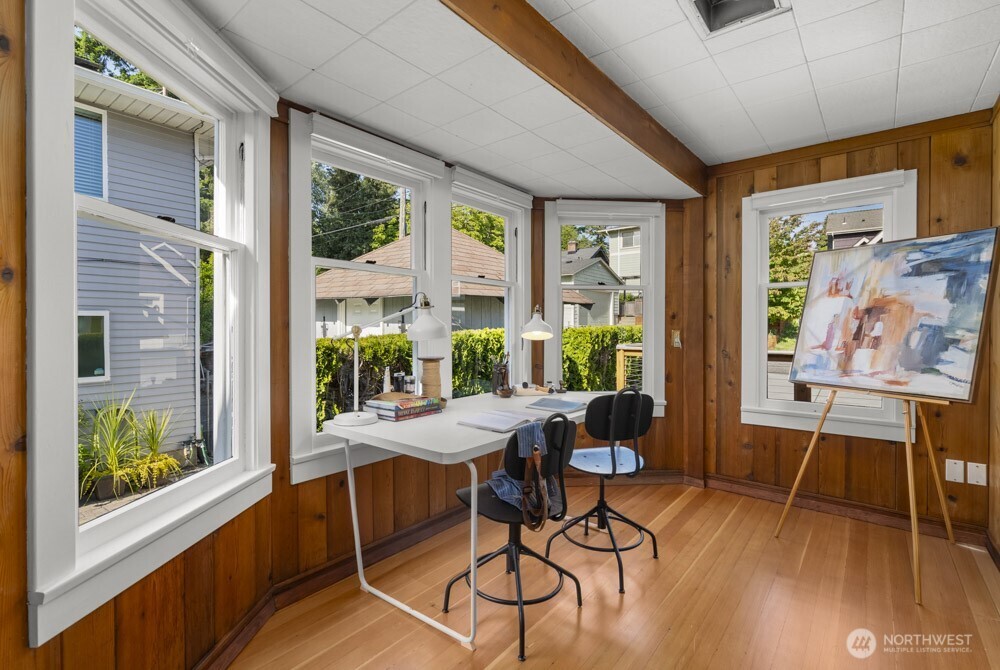 4146 47th Avenue Southwest Seattle, WA 98116 - Photo 18 of 40 a dining room with furniture large windows and wooden floor