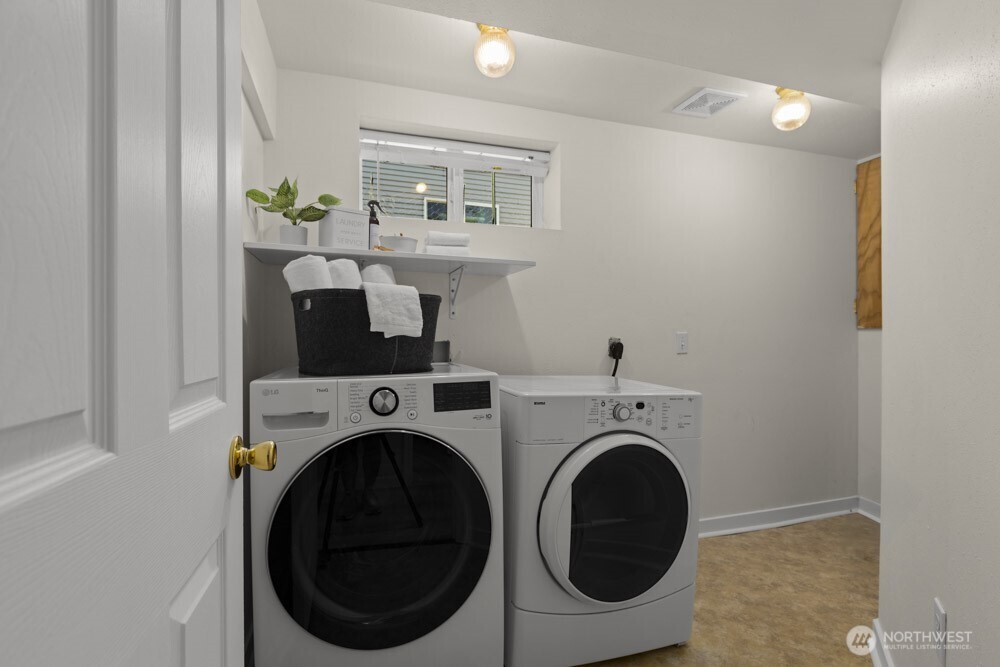 4146 47th Avenue Southwest Seattle, WA 98116 - Photo 19 of 40 a view of a storage & utility room with washer and dryer