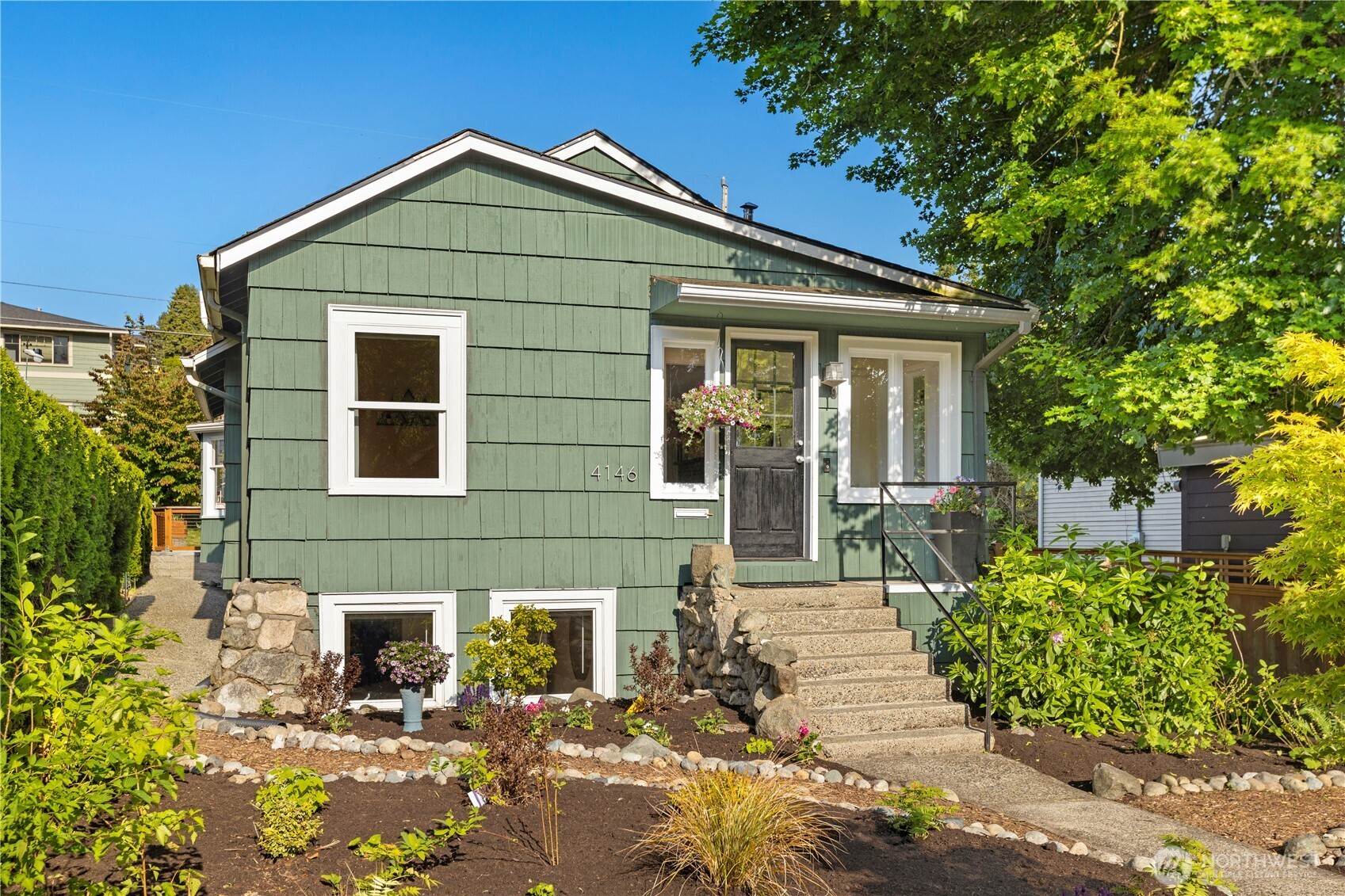 4146 47th Avenue Southwest Seattle, WA 98116 - Photo 2 of 40 a front view of a house with garden