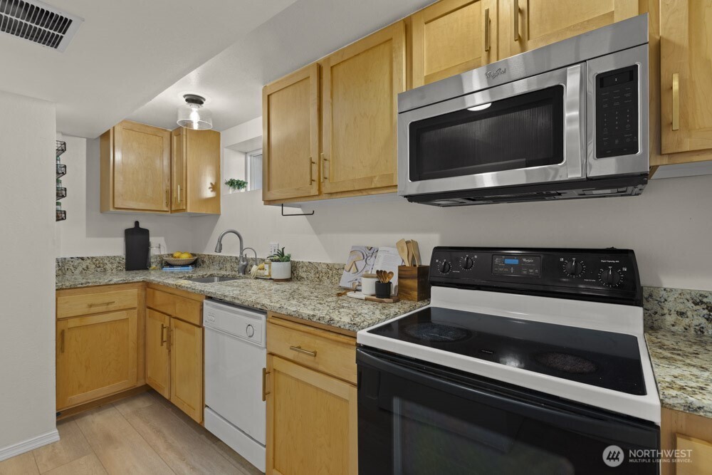 4146 47th Avenue Southwest Seattle, WA 98116 - Photo 24 of 40 a kitchen with a stove and a microwave