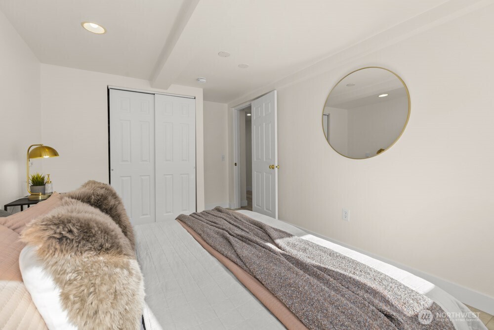 4146 47th Avenue Southwest Seattle, WA 98116 - Photo 26 of 40 a bedroom with a bed and a painting on the wall