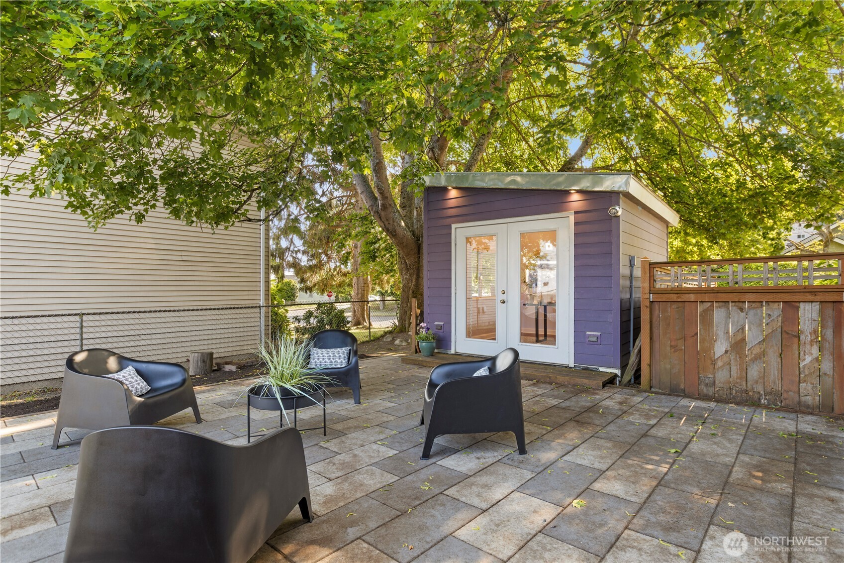 4146 47th Avenue Southwest Seattle, WA 98116 - Photo 34 of 40 a view of a patio with table and chairs and wooden fence