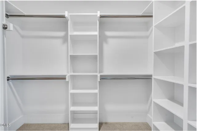 a view of walk in closet with empty racks
