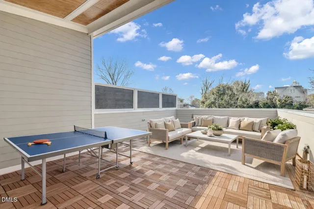 a roof deck with a table and chairs