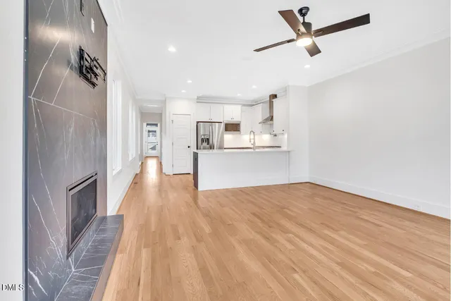 a view of a kitchen with a sink and wooden floor