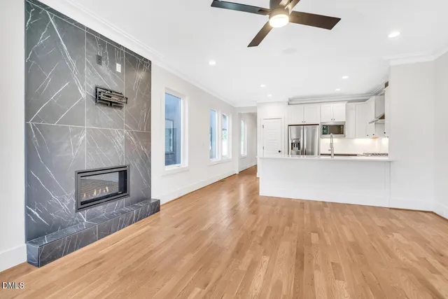 a view of a kitchen with wooden floor and a ceiling fan