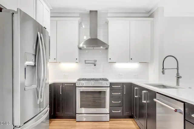 a kitchen with granite countertop a refrigerator and a sink