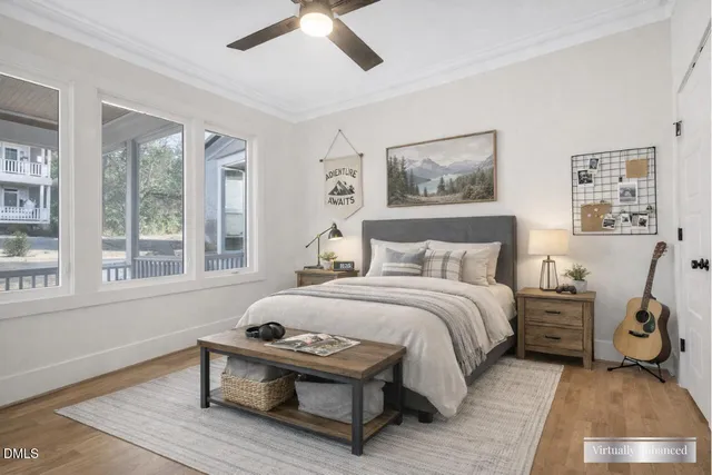 a bedroom with a bed and wooden floor