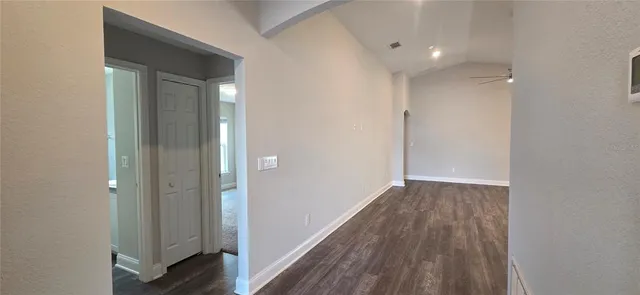 a view of hallway with wooden floor