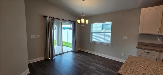 a view of an entryway with wooden floor and door