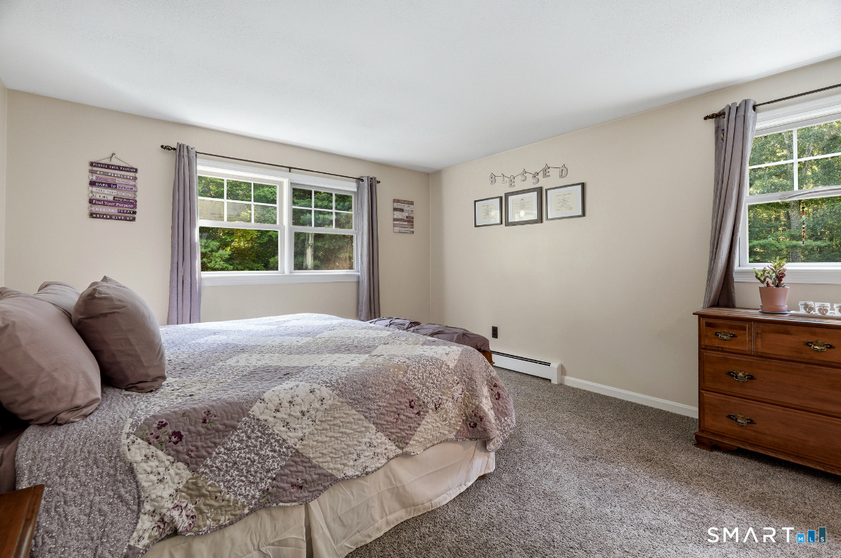 84 Christy Hill Road Ledyard, CT 06335 - Photo 16 of 27 a large bed sitting in a bedroom next to a window