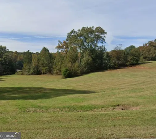 a view of a field with an ocean beach